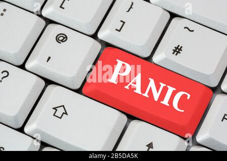 Eine Tastatur mit Panik, die in weißer Schrift auf einer roten ENTER-Taste geschrieben ist. Panic Button Konzept, erste Hilfe Farben. England, Großbritannien, Großbritannien Stockfoto