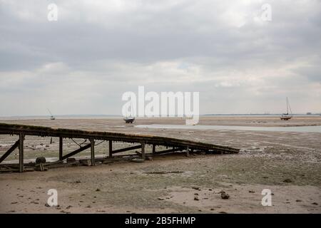 Fischerboote steckten in Leigh-on-Sea, Großbritannien, in der Zeit der Ebbe am Strand. Stockfoto