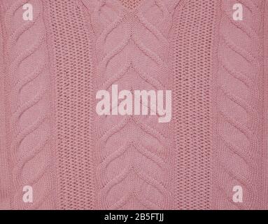 Gestrickte Litzen pinkfarbener Pullover Material Leinwandtextur. Stockfoto