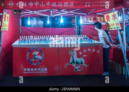 Guilin, China - 9. Mai 2010: Zhong Shan Road Abendmarkt. Kleine Parfümflaschen aus Glas in verschiedenen Kolros am Messestand mit starkem Licht in der Nacht. Vend Stockfoto