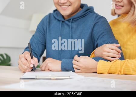 Asiatisches glückliches Paar erhält Schlüssel und Handschlag mit Realtor-Agent mit lächelndem Gesicht in neuem Haus.Kauf neuer Hausimmobilien Stockfoto