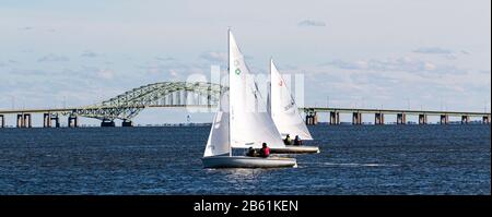 7. Dezember 2019: Zwei kleine Segelboote, die sich in einer Winterregatta vor der Großen South Bay Brücke am Südufer von Long Island gegenseitig Rennen. Stockfoto