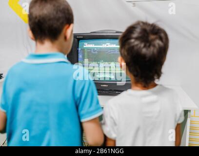 Ultra MALL, UFA, RUSSLAND, 21. AUGUST 2017: Zwei Jungs spielen begeistert ein Retro-Videospiel auf der Spielkonsole Stockfoto