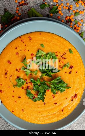 Indische Dhal würzige Curry in Schüssel, Gewürze, Kräuter, rustikaler grauer Holzhintergrund. Authentisches indisches Gericht. Makro Stockfoto