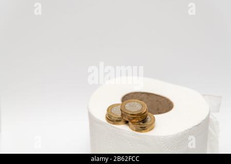Toilettenpapier mit britischem Pfund Münzen Geld Stockfoto