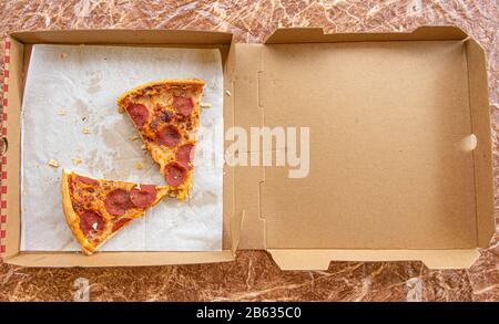 Veraltete, übrig gebliebene Pizzabäckchen in der Pizza-Lieferbox Stockfoto