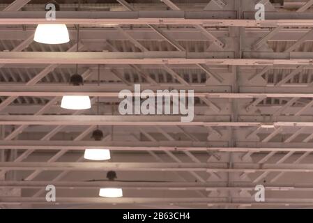 Decke im Hangar. Die Beleuchtung an der Decke in einem großen Raum. Weiße hohe Decken. Stockfoto