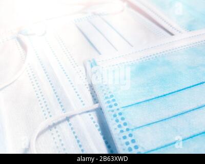 Blau-weiße medizinische Gesichtsmasken. Makroansicht für Hintergrund. Stockfoto