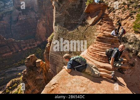 Wanderer auf dem Angels Landing Trail, Endanstieg in der Nähe von Scout Lookout, Zion Canyon auf der linken Seite, Zion National Park, Utah, USA Stockfoto