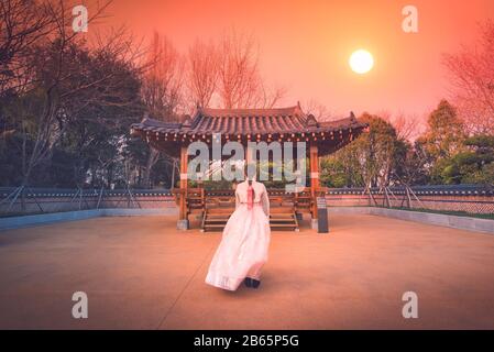 Asiatische koreanische Mädchen verkleideten Hanbok in traditionellem Kleid bei Sonnenuntergang in Südkorea. Stockfoto