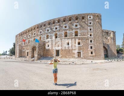 Touristenreisen im alten zerstörten griechischen Stadttheater von Aspendos in der Türkei Stockfoto