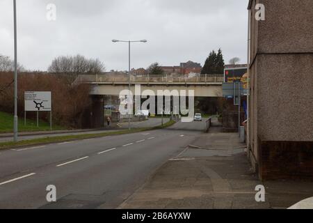 Eine Eisenbahnbrücke, die an einem stumpfer und trostlosen Tag die A483 in den Vororten von Swansea in Südwales überquert. Stockfoto