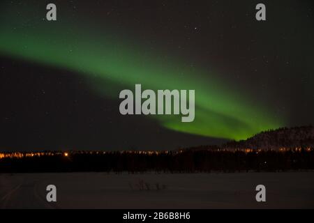 Wunderschöne grüne Nordlichter (Aurora Borealis) in Luosto, Lappland, Finnland mit klarem Himmel und Sternen. Stockfoto