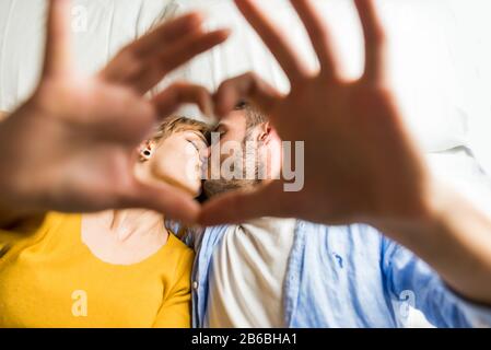 Zwei junge Erwachsene zu Hause - Wunderschönes glückliches Liebespaar, das Spaß im Bett hat Stockfoto