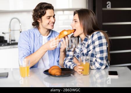 Glückliches Paar essen Frühstück in der Küche Stockfoto