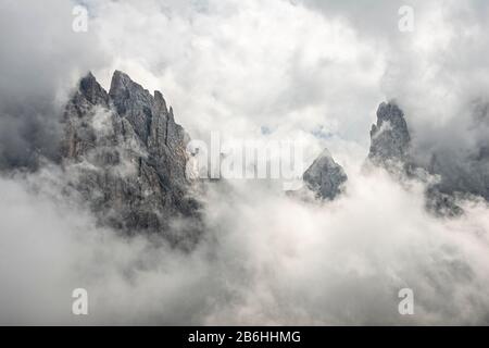 Wolkenbedeckte Felsspitzen, Berggipfel der Geisler-Gruppe, Villnoesstal, Doles, Südtirol, Italien Stockfoto