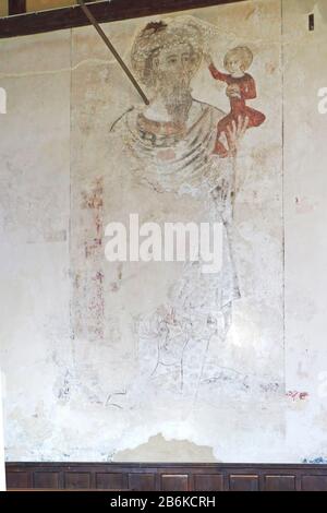 Ein Blick auf ein Mittelaltergemälde von St. Christopher, das das heilige Kind in der Pfarrkirche St Margaret in Paston, Norfolk, England, Großbritannien, Europa trägt. Stockfoto