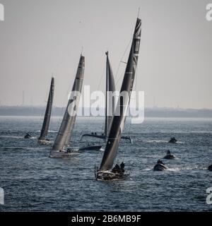 4 Jachten und verschiedene kleine Boote segeln während des Inselrennens auf dem solent an einem hellen Sommertag auf die Kamera. Stockfoto