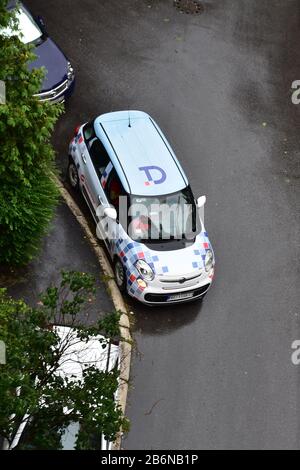 Geparktes weißes Auto mit Mustern neben dem Bürgersteig Stockfoto