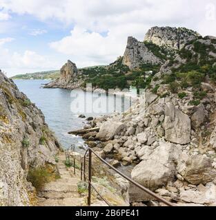 Steile Steintreppe hinunter vom Diva Felsen im Dorf Simeiz. Eine beliebte Touristenattraktion an einem trübem Sommertag Stockfoto