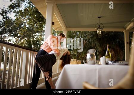 Lächelnd Mitte - erwachsene Paare tanzen zusammen auf einem Balkon. Stockfoto