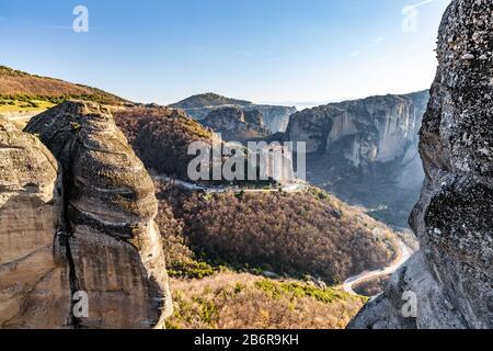 Luftbild des Klosters Rousanou und atemberaubendes malerisches Tal und Wahrzeichen von Meteora bei Sonnenuntergang, Kalambaka, Griechenland, Schatten, verdreht Stockfoto