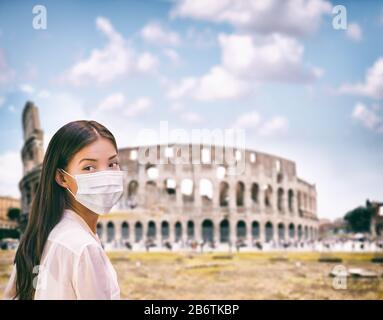 Corona-Virus Italien reisen chinesische Asiaten, die einen chirurgischen Gesichtsmasken-Coronavirus-Schutz am wahrzeichen von colosseum in Roma, Italien tragen. Quarantäne von kranken Flugtouristen zu italienischen Zielen. Stockfoto