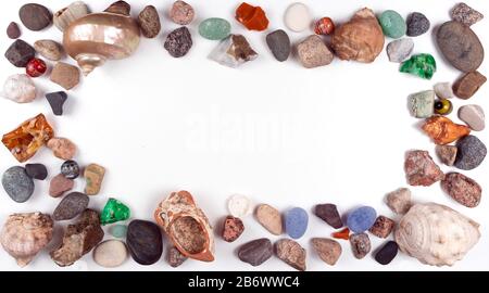 Bilderrahmen aus Muscheln und Kieselsteinen auf hellem Hintergrund mit Platz für Ihren Text oder Ihr Foto Stockfoto