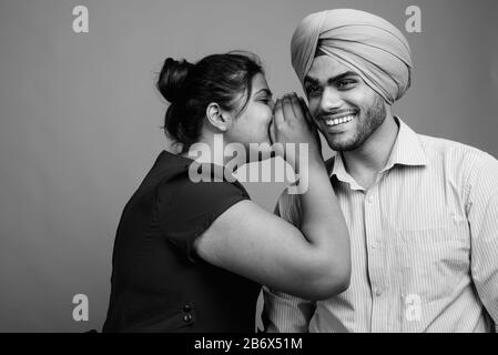 Junges indianisches Paar zusammen und verliebt sich vor grauem Hintergrund Stockfoto