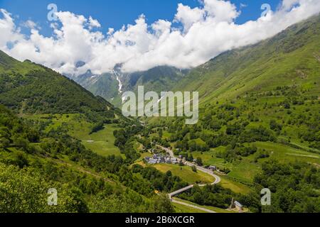 Dorf Le Plan, Haute Garonne, Occitanie, Frankreich. Die D118 führt durch den Ort und zum bergigen Pyrenäen-Nationalpark jenseits. Stockfoto