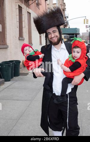 Porträt einer orthodoxen jüdischen Familie auf Purim. Die Kinder tragen Kostüme wie die Urlaubstradition. Williamsburg, Brooklyn, New York. Stockfoto