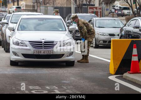 Soldaten der U.S. Army Garrison Casey (Südkorea) führen Vorsorgeverfahren für Coronavirus für Personen durch, die auf den Eintritt in die Basis warten. Stockfoto