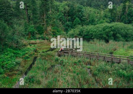 Ein junges Paar genießt eine Wanderung auf einer Promenade im pazifischen Nordwesten. Stockfoto