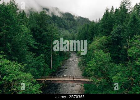 Ein junges Paar genießt eine Wanderung auf einer Brücke im Pazifischen Nordwesten. Stockfoto