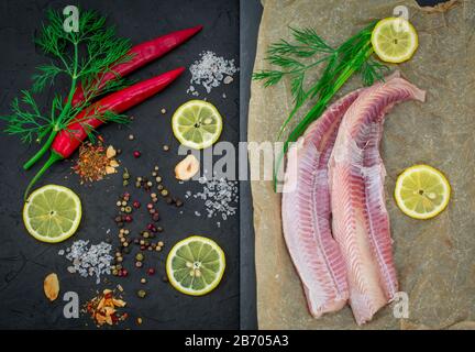 Fischfilets von Dogfish mit Zitronenkräuter auf schwarzem Grund Stockfoto