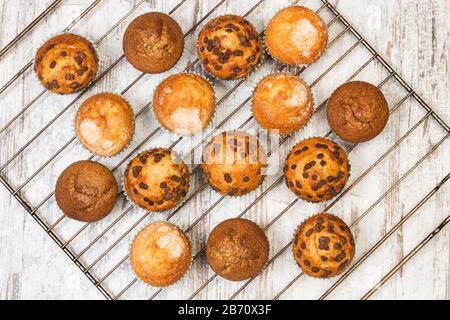 Verschiedene Cupcakes auf einem Backrohr auf einem Holztisch Stockfoto
