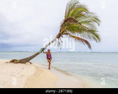 San Blas, Panama - 25. Februar 2020: Weiblicher Tourist unter Palmen an Einem Wunderschönen einsamen Strand in der karibischen Insel San Blas., Panama. Stockfoto