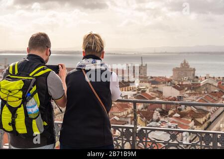 Lissabon, Portugal - 2. März 2020: Touristen, die den Blick vom Elevador de Santa Justa aus betrachten. Arco da Rua Augusta im Hintergrund. Stockfoto