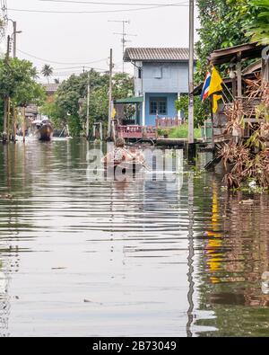 Ältere Frauen rudern auf einem kleinen Holzboot in einem Kanal im Zentrum von Bangkok, Thailand Stockfoto