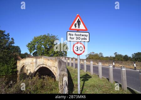 Kein Fußraum für Fußgänger in vorausfahrender Straße Warnschild auf Brücke, die den Fluss derwent in sutton auf derwent united Kingdom überquert Stockfoto