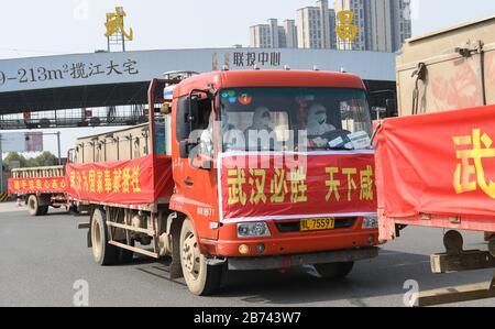 (200313) -- WUHAN, 13. März 2020 (Xinhua) -- Mit Fisch beladene Lkws gelangen in Wuhan, die zentralchinesische Provinz Hubei, am 13. März 2020. Die erste Charge von 100 Tonnen Fisch, die aus Hubeis Xianning City transportiert wurden, wurde am Freitag an Gemeinden im Qiaokou Distrikt Wuhan verteilt. (Xinhua/Cheng Min.) Stockfoto