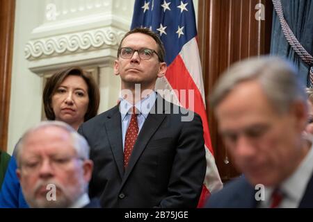 Texas, USA. März 2020. Texas Education Commission Mike Morath hört zu, wie Texas reg. Greg Abbott erklärt auf einer Pressekonferenz in Austin eine landesweite "Katastrophenkatastrophe" als texanische Klammern für einen Ansturm von Coronavirus-Fällen. Credit: Bob Daemmrich/Alamy Live News Stockfoto