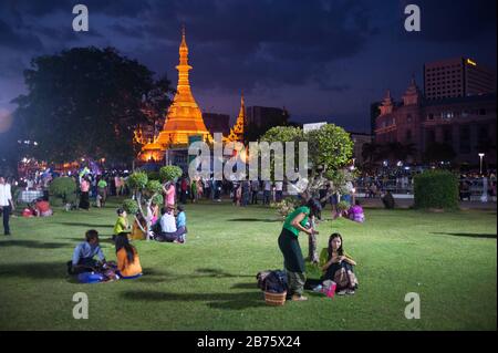 27.01.2017, Yangon, Yangon Region, Republik der Union von Myanmar, Asien - Einheimische entspannen sich im beliebten Maha Bandula Park in Yangon, während Sule Pagode im Hintergrund glänzt. [Automatisierte Übersetzung] Stockfoto