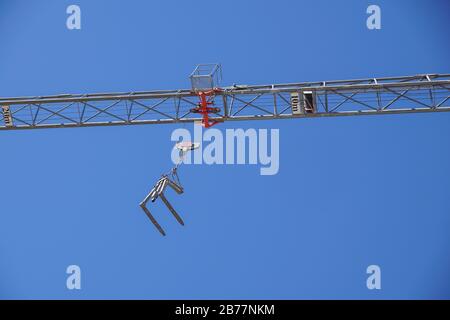 Detail ein rostiger Kranhaken und Stahlseile, die an einem blauen Himmel hängen Stockfoto