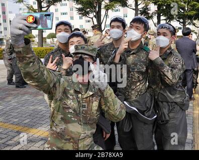 Daegu, Südkorea. März 2020. US-Soldaten und südkoreanische Soldaten nehmen ein selfie, während sie gemeinsam einen Apartmentkomplex aus dem COVID-19, Coronavirus 13. März 2020 in Daegu, Südkorea desinfizieren. Der Ausbruch des neuartigen Coronavirus in Südkorea ist an zweiter Stelle nur für China. Kredit: Kevin Bell/Planetpix/Alamy Live News Credit: Planetpix/Alamy Live News Stockfoto