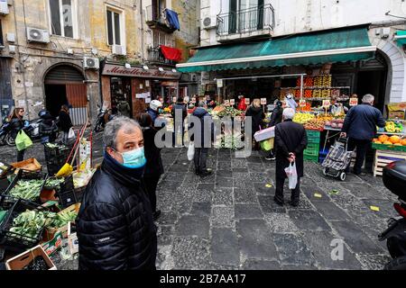 Neapel, Italien. März 2020. Menschen, die Schutzmasken und Handschuhe tragen, auf einem Markt in der Stadt Neapel, nachdem ein Regierungsdekret ganz Italien zu einem Schutzgebiet erklärt hatte, um die Kovid-19-Coronavirus-Infektion zu bekämpfen. Kredit: Unabhängige Foto-Agentur Srl/Alamy Live News Stockfoto