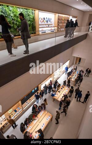 Kunden, die Apple Produkte im Apple Store auf der Champs-Elyssees Avenue in Paris, Frankreich, Europa, durchsuchen Stockfoto