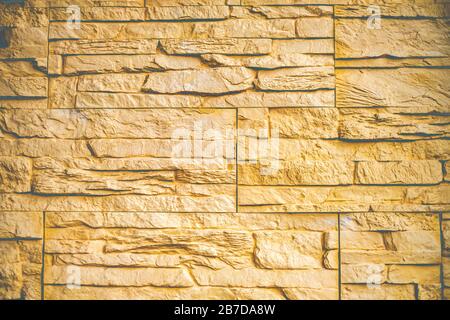 Hintergrund mit beigefarbener Backstein-Wandstruktur Stockfoto