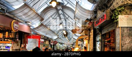 Ein computergroßes Banner zeigt einen Teil der Ladenschilder und die Decke des Hallenmarktes Mahane Yehudah in Jerusalem. Stockfoto