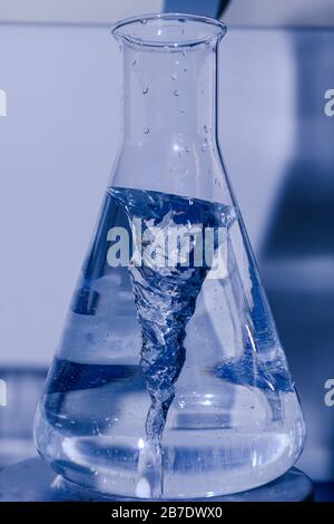 Erlenmeyerkolben drehen im Bioscience-Labormischer. Konzept der Wissenschaft, des Labors und der Erforschung von Krankheiten. Stockfoto